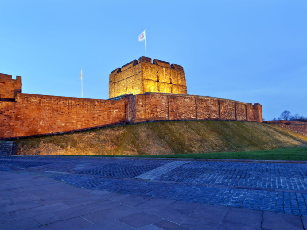 Exterior view of Carlisle Castle lit up at night